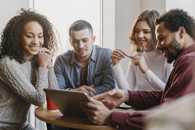 four people having a meeting